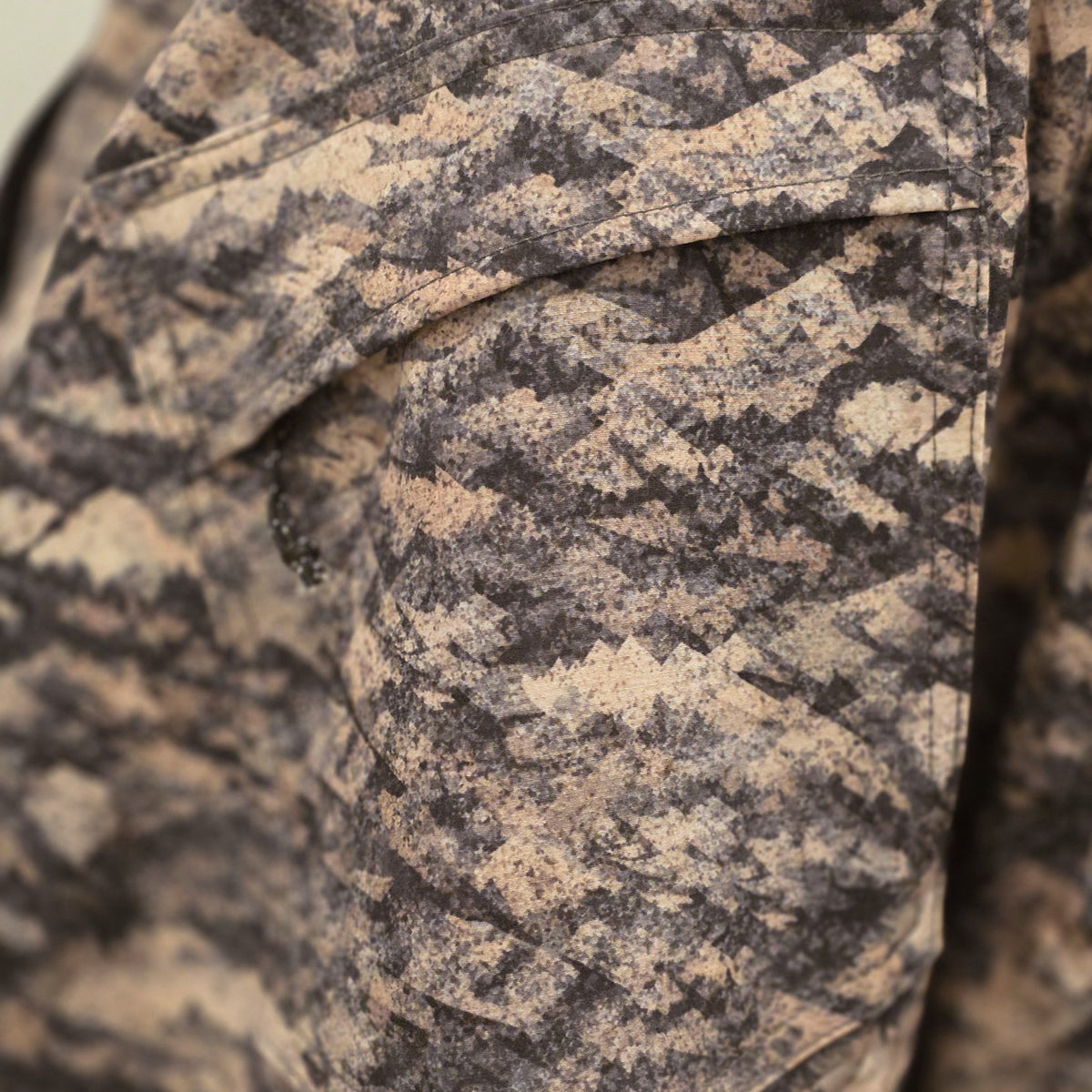 Zippered flap back pocket on the Grave Point Pant up close, showing the Canyon Ghost mountain camo pattern