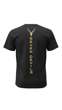 A black short-sleeve t-shirt shown from the back, featuring a vertical gold graphic with a Seven devils skull and the text 'SEVEN DEVILS'.