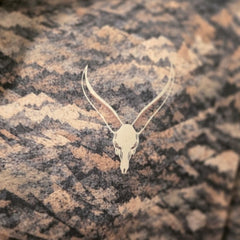 Close-up of the Seven Devils skull logo on the chest of the Grave Point Hoody in Canyon Ghost camo